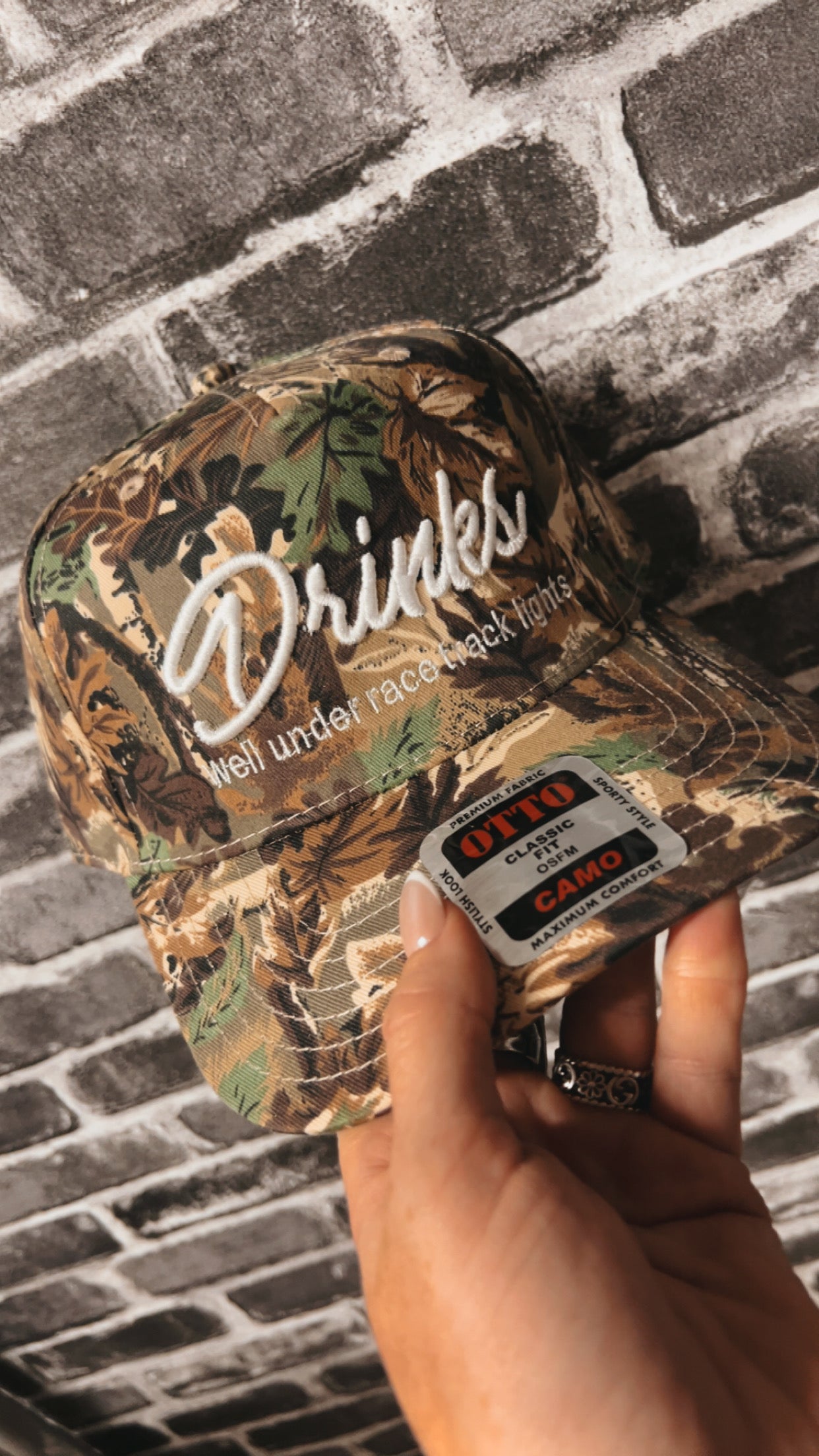 “Drinks Well Under Race Track Lights” Hat